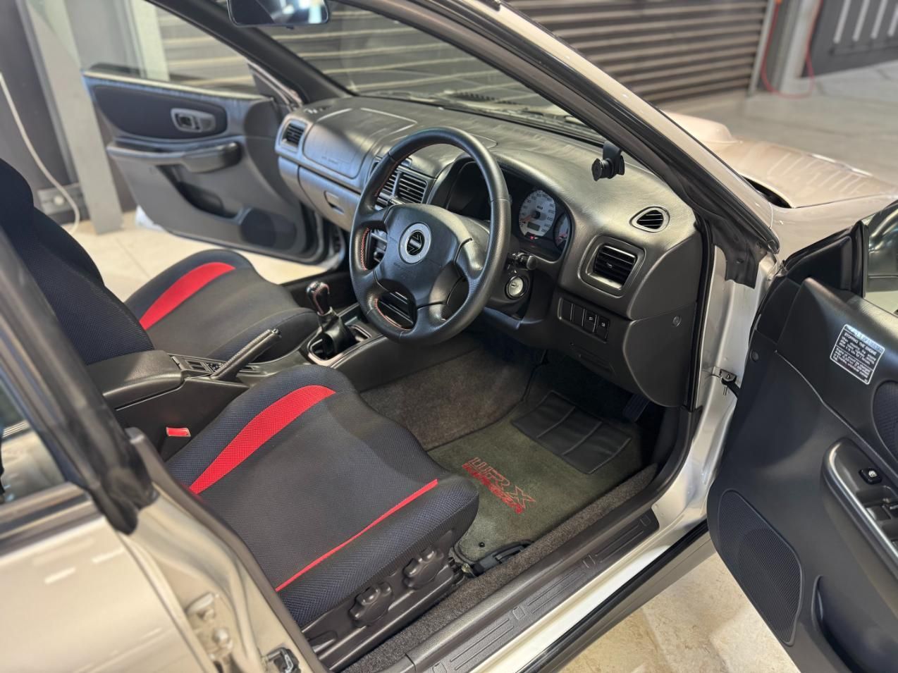 The Interior Of A White Car With Red And Black Seats And A Steering Wheel — The Works Auto Salon In East Bendigo, VIC