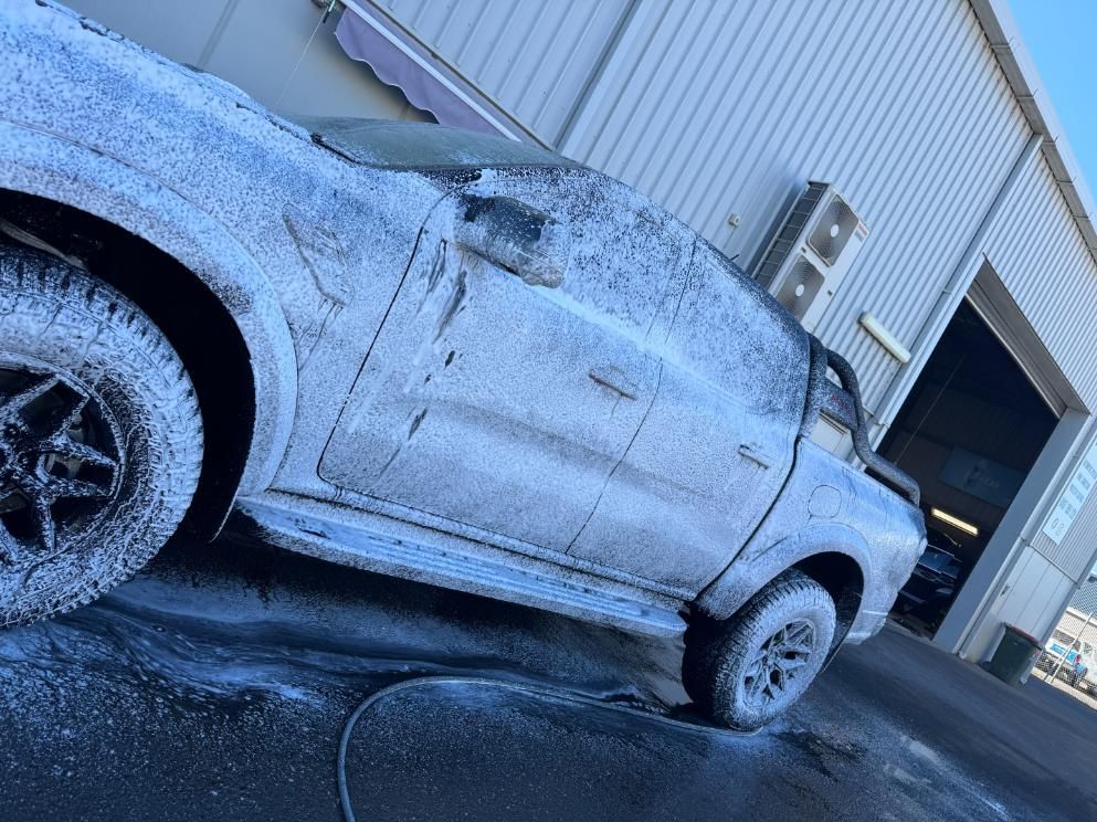A Truck Is Covered In Foam In Front Of A Building — The Works Auto Salon In East Bendigo, VIC