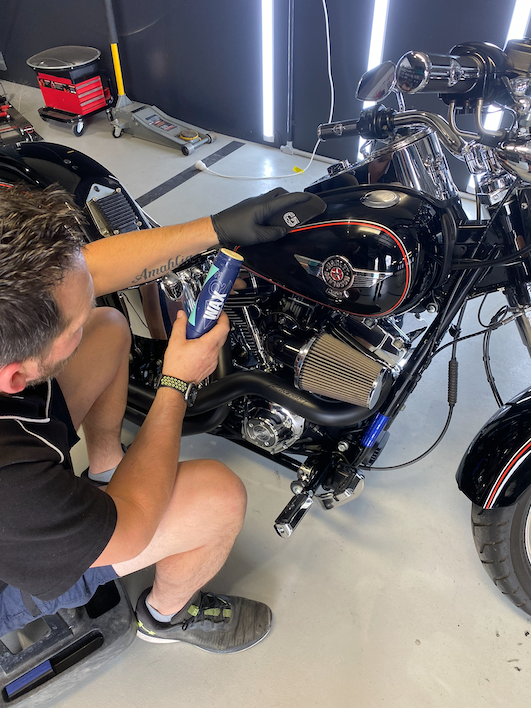 A Person Fixing Harley Davidson Motorcycle Parked In A Garage — The Works Auto Salon In East Bendigo, VIC