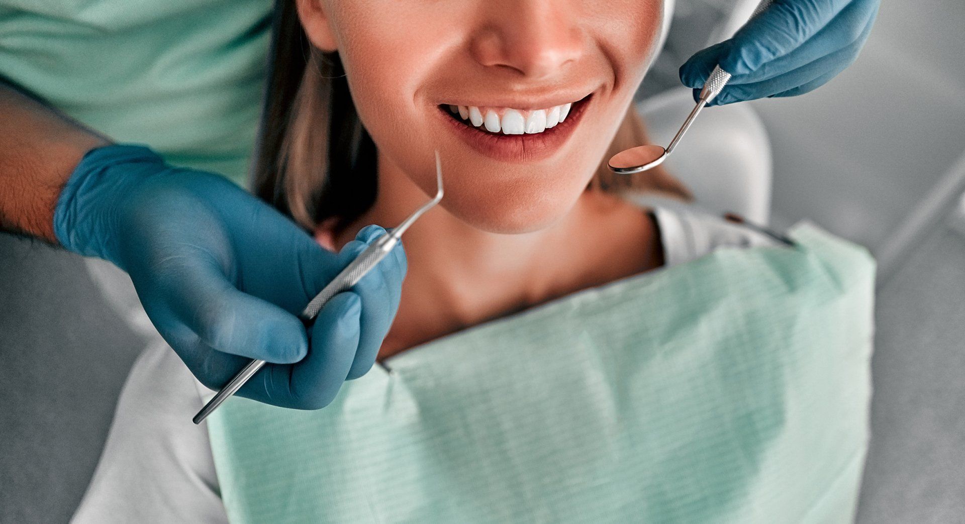 Dentist Examining Teeth Of Female Client — Newport News, VA - Tidewater Prostho
