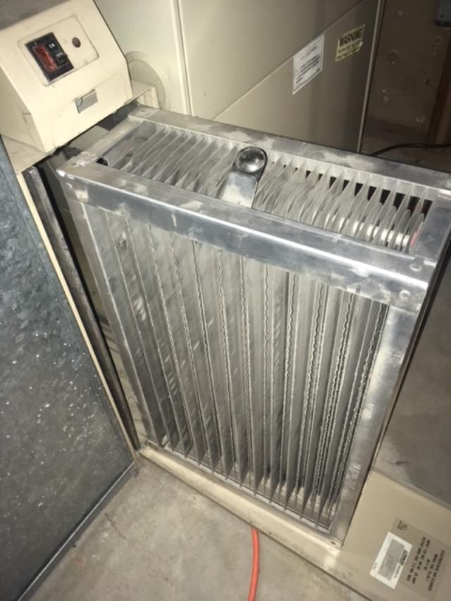 A dirty air filter is sitting next to a heater.