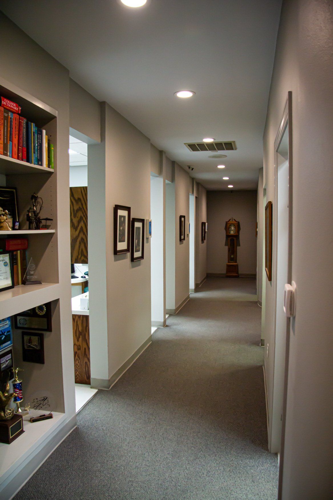 A long hallway with a clock on the wall