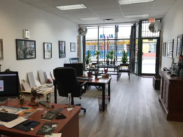 Office interior with desks, art, and a large window.