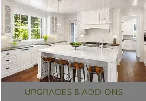 Bright white kitchen with island, stools, and upgrades text.
