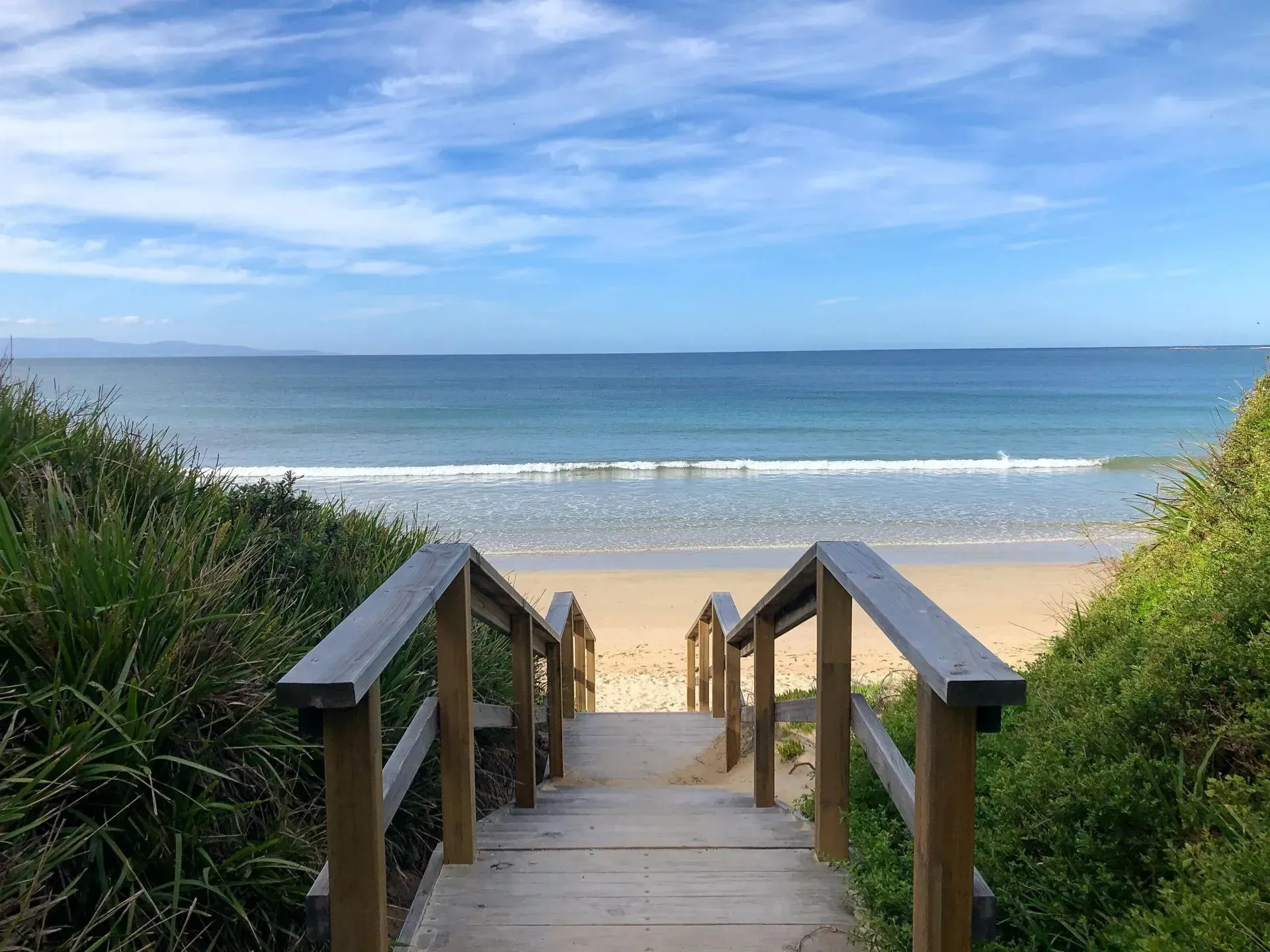 Wooden Stairs Lead Down to a Sandy Beach — Phil Lindfield's Big Red Carpet Cleaning In Tallwoods Village, NSW