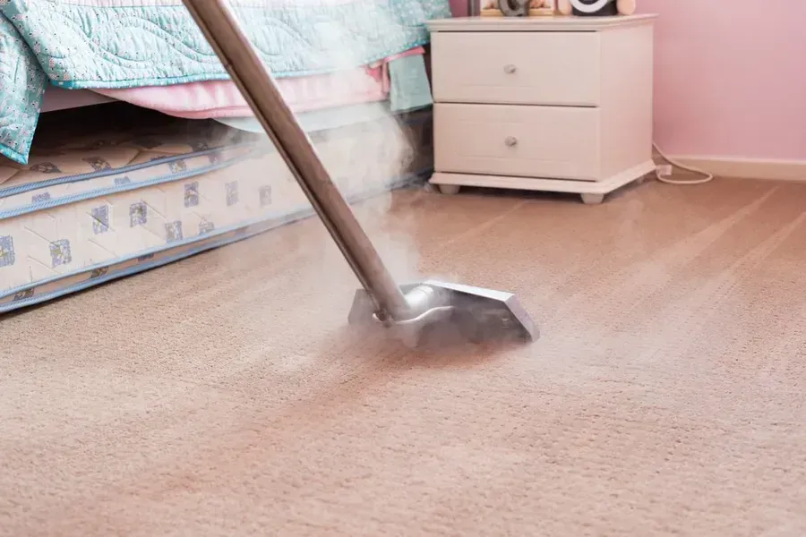 Steam Cleaner Cleaning a Beige Carpet — Phil Lindfield's Big Red Carpet Cleaning In Forster, NSW