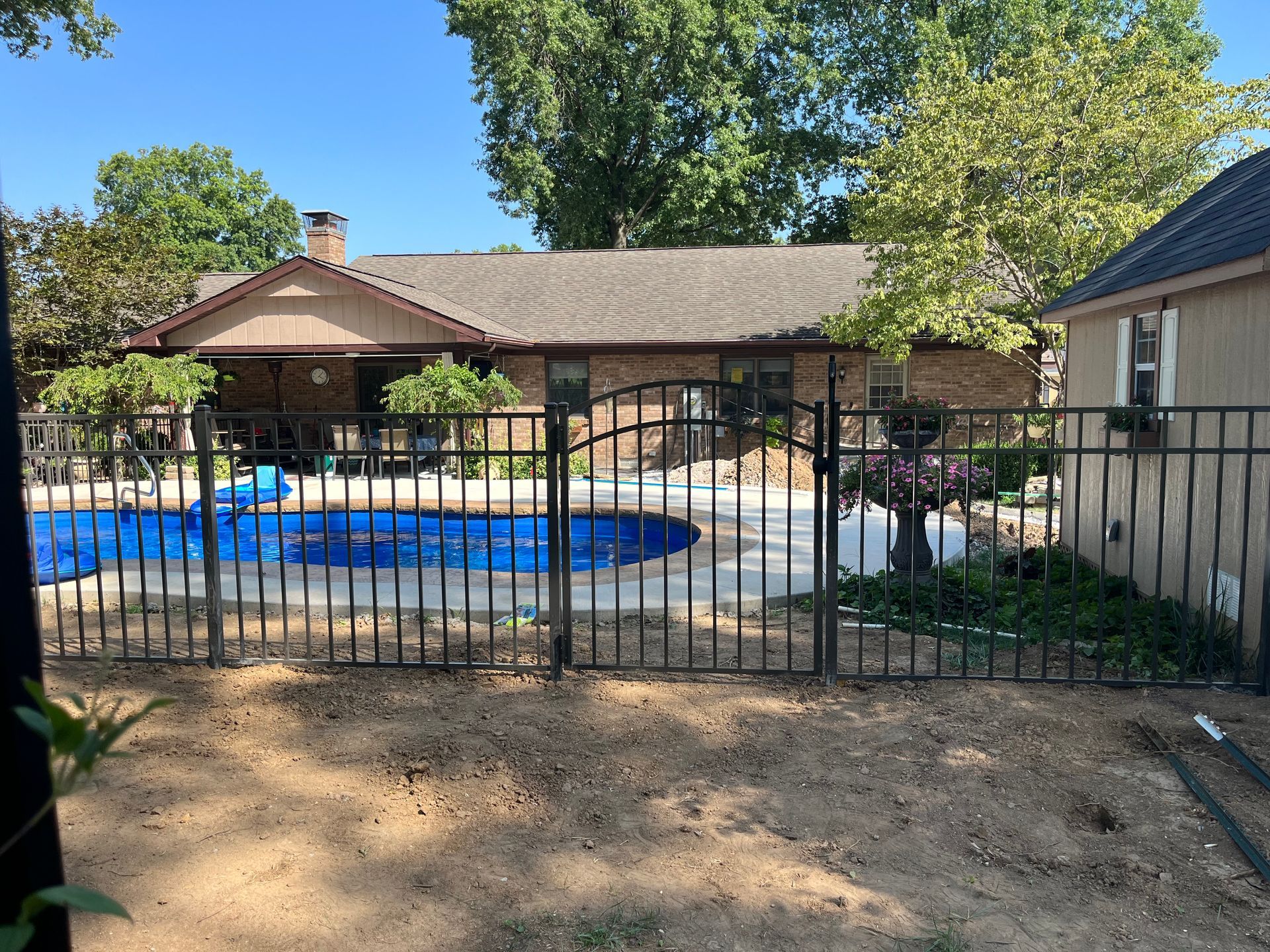 A House with A Pool Behind A Metal Fence — Troy, IL — Osborne Fence LLC
