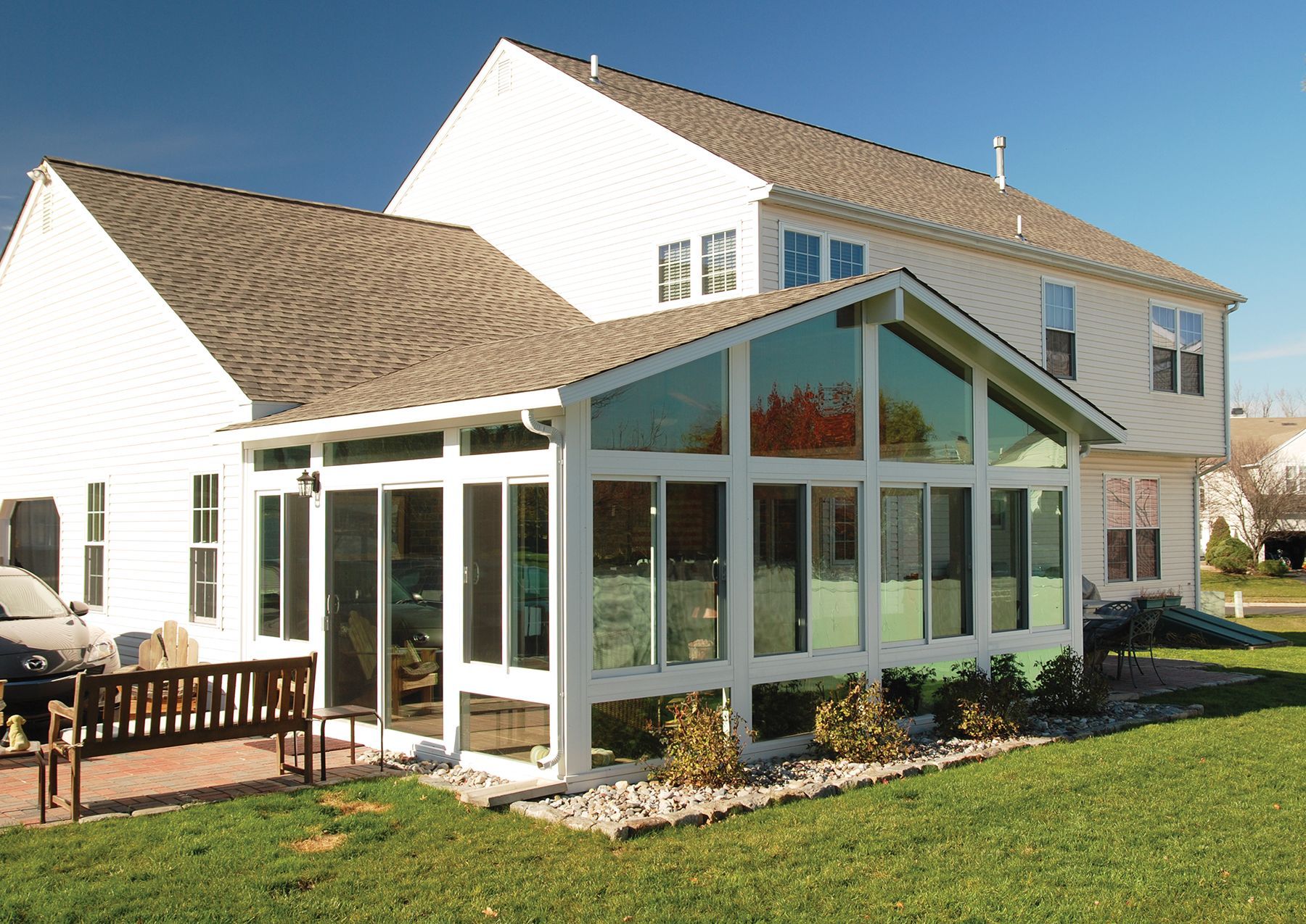 a white house with a large sunroom on the side