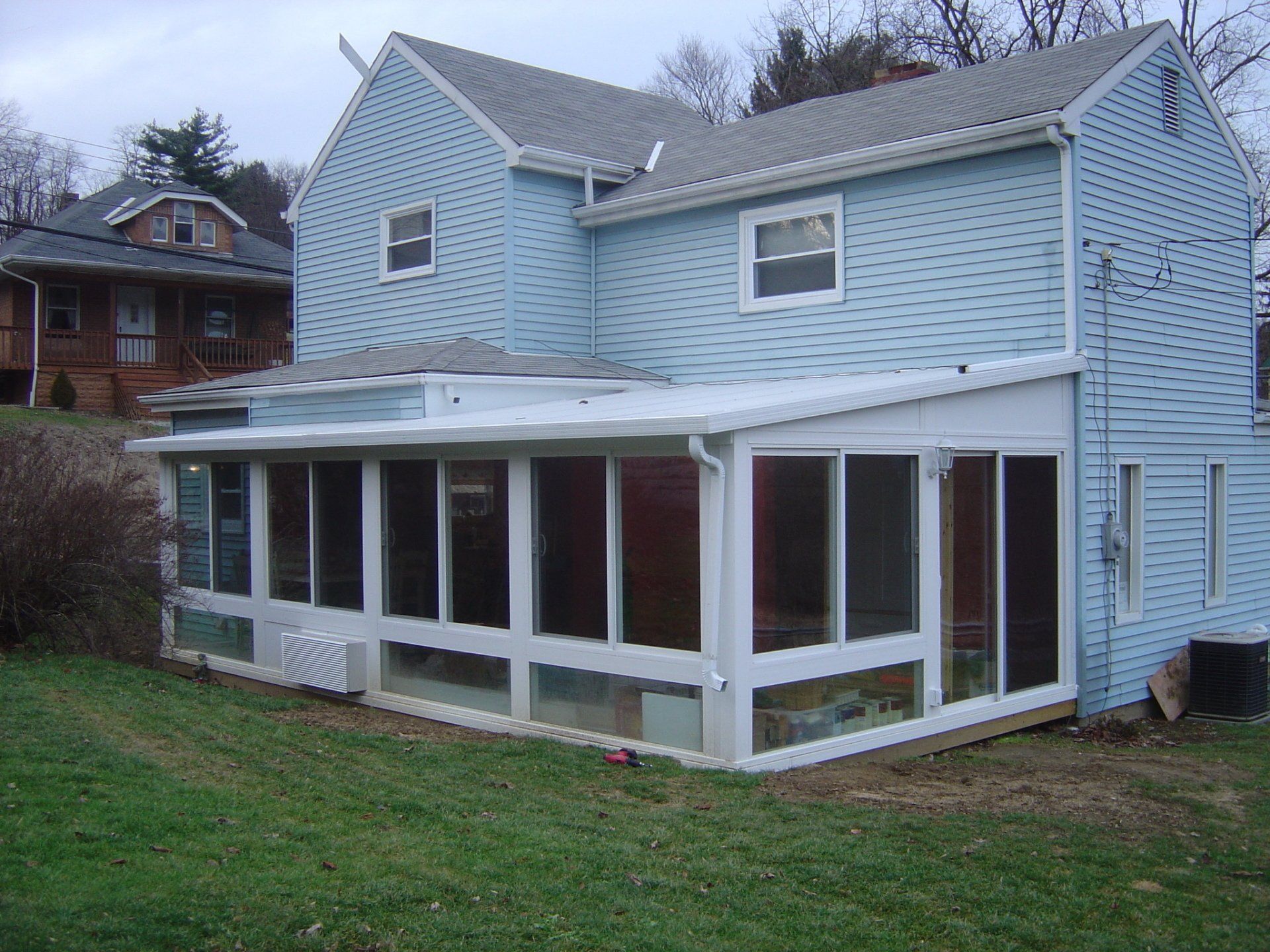 Before and after photo slider show a before picture and after picture of a patio room built by Betterliving Patio Rooms of Pittsburgh