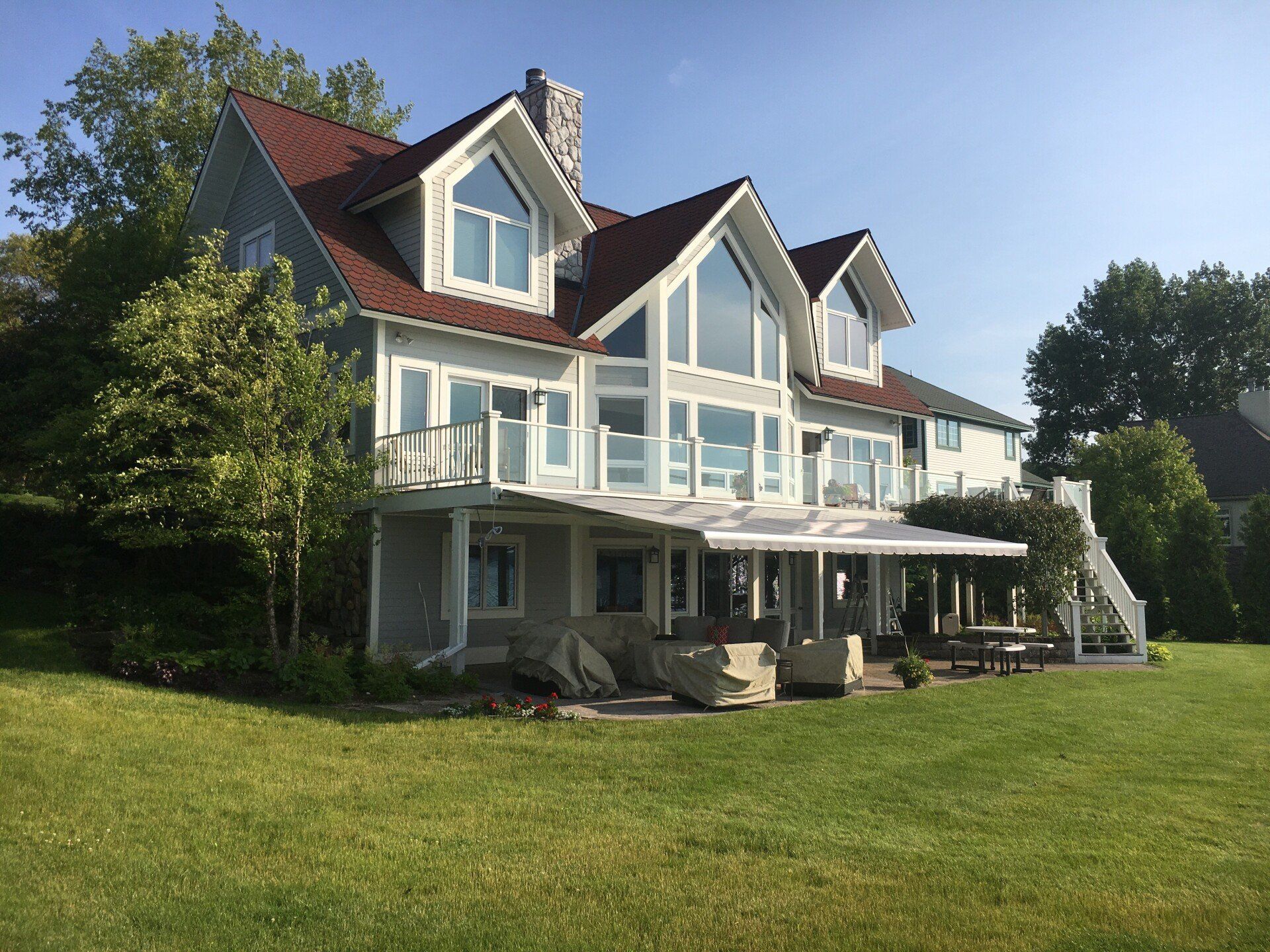 A large white house with a red roof and lots of windows