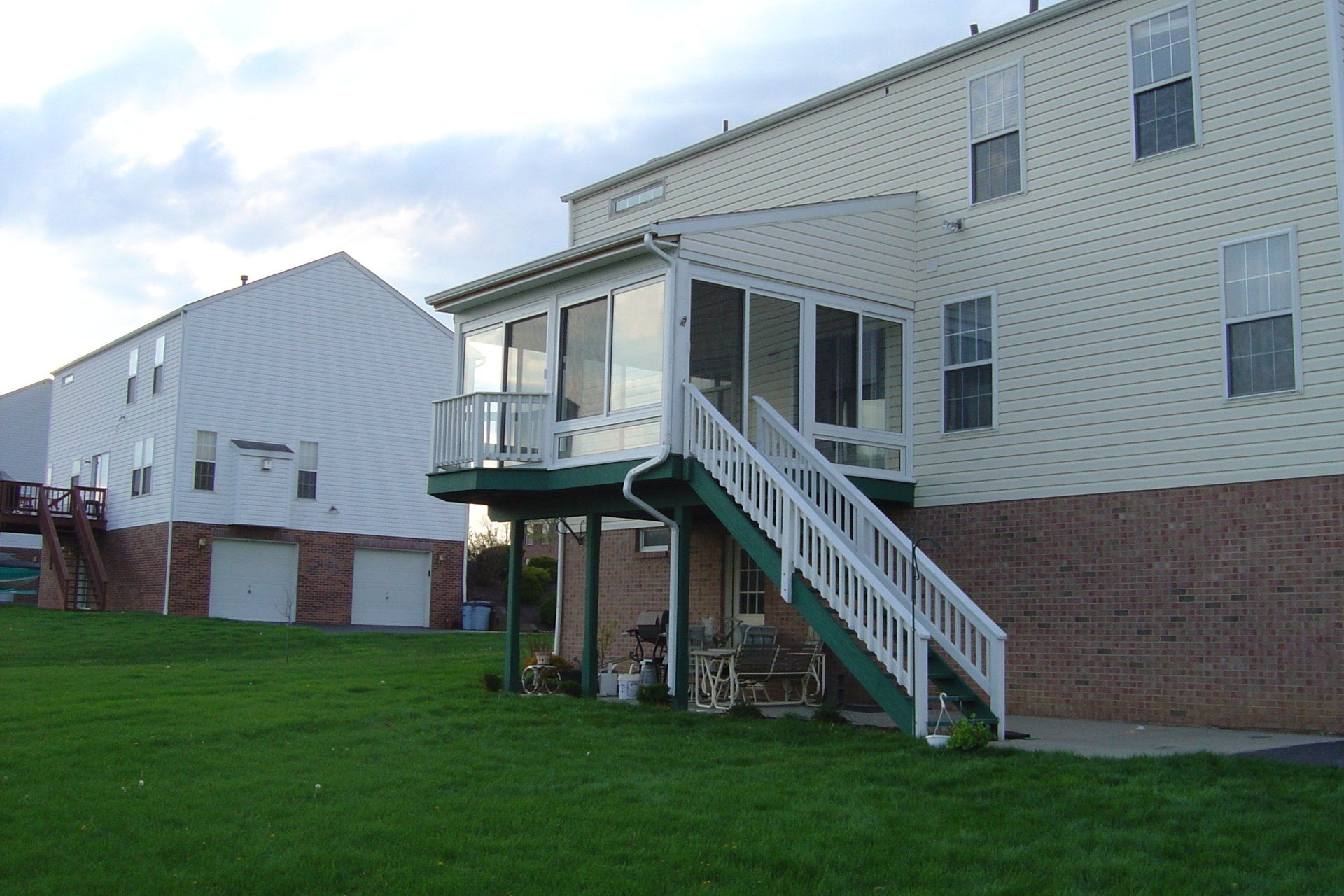 A house with a screened in porch and stairs