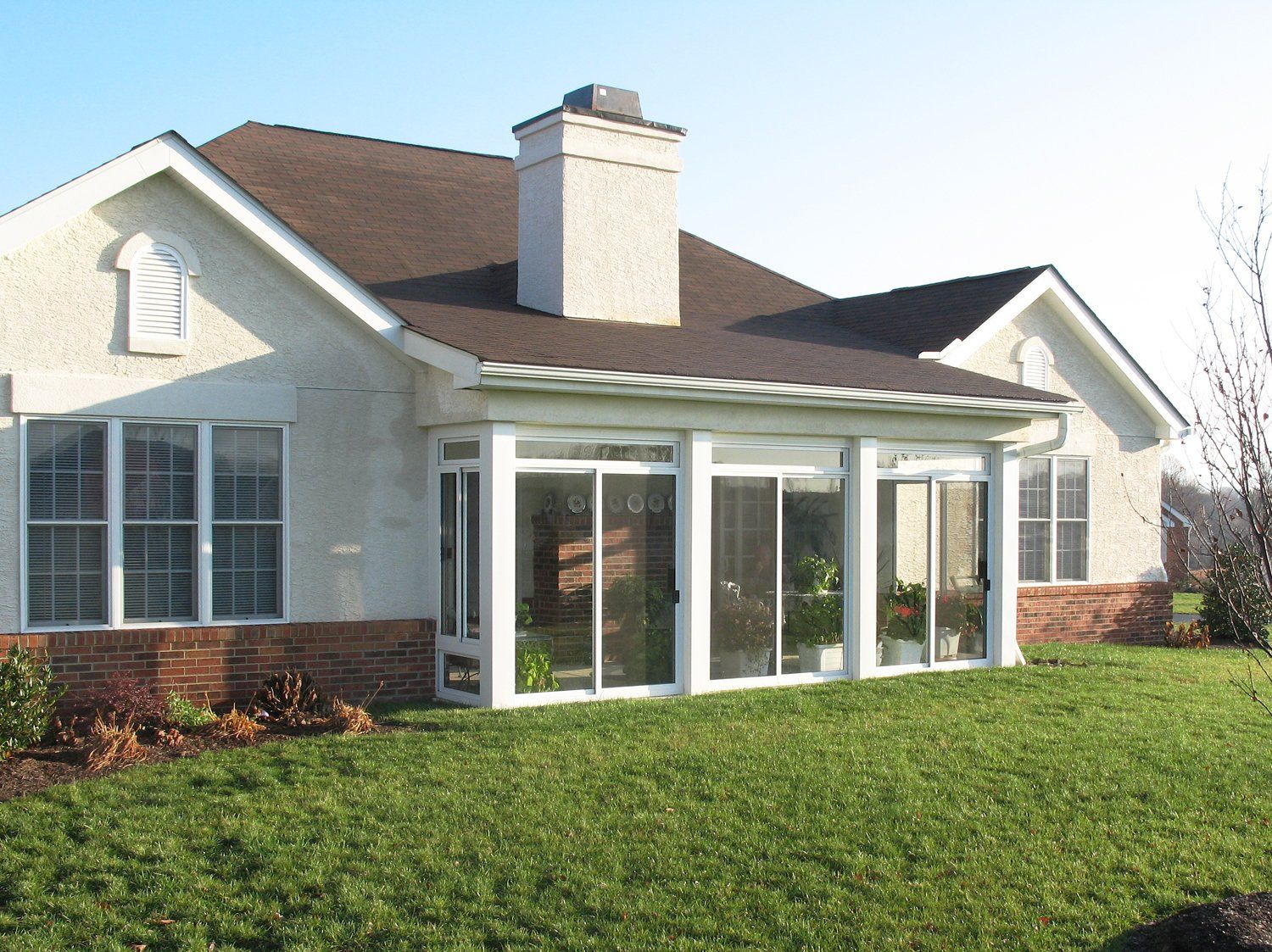A house with a lot of windows and a chimney