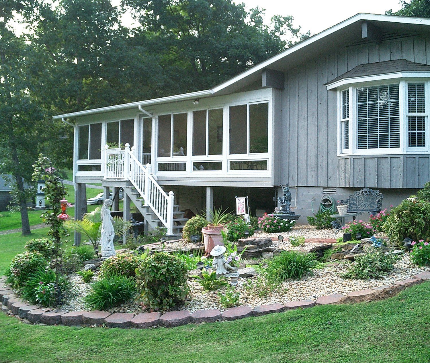 A house with a screened in porch and stairs