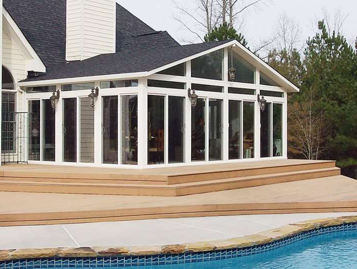 A house with a swimming pool in front of it