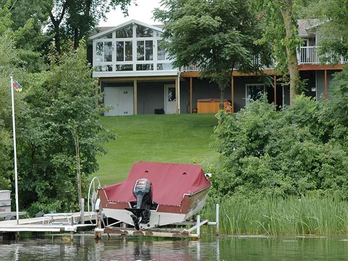 A boat is sitting on a dock in front of a house