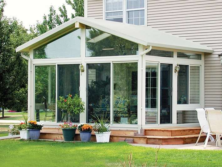 A house with a sunroom with lots of windows