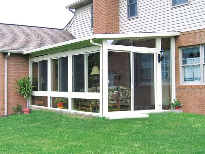 A house with a screened in porch with a lot of windows