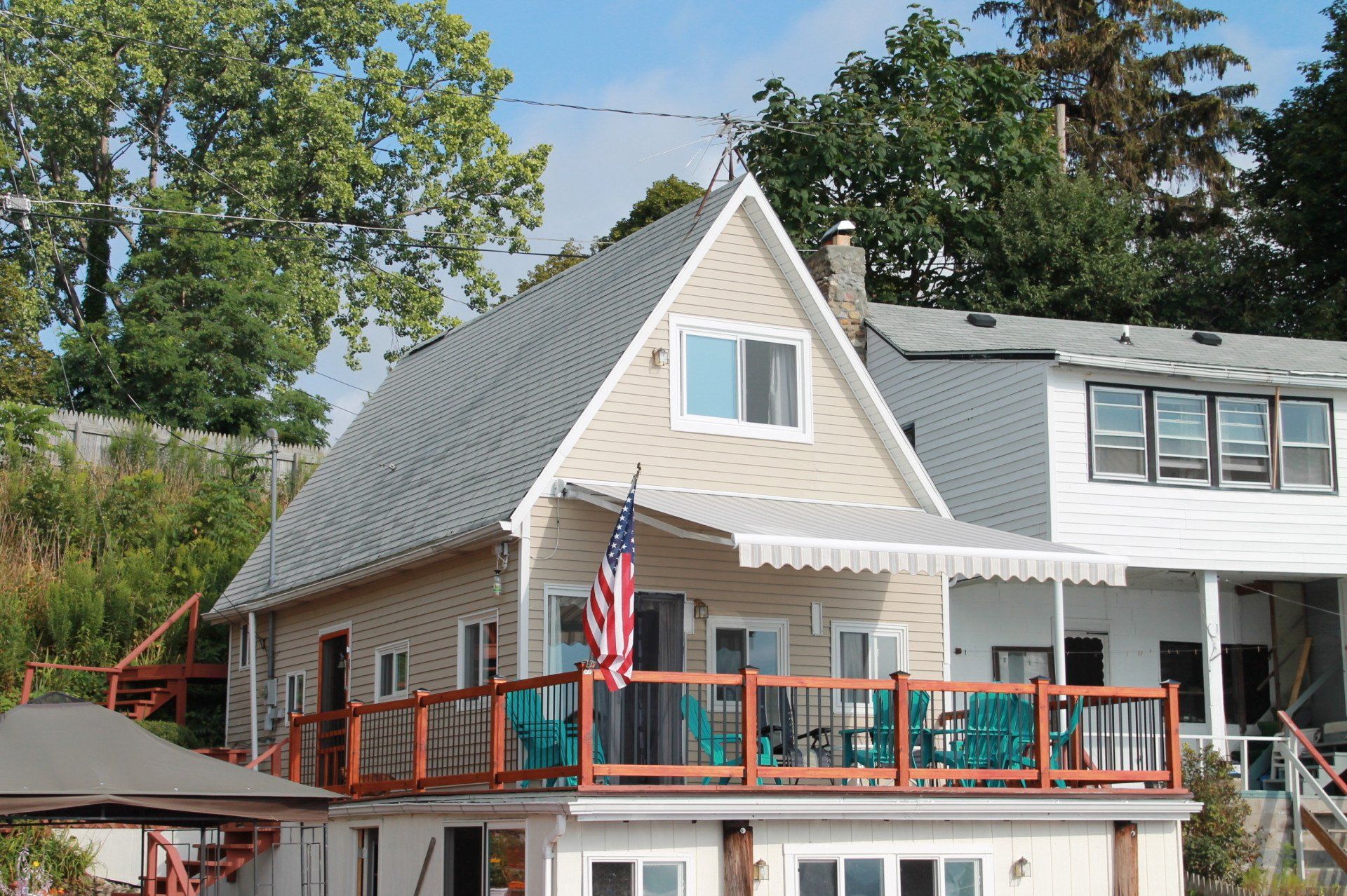 A house with a balcony and an american flag on it