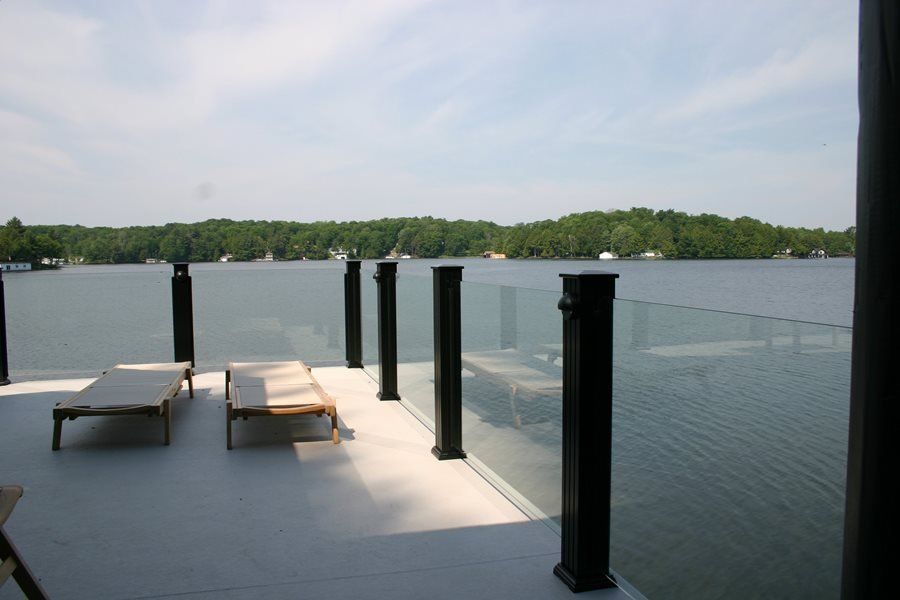 A dock with chairs and a view of a lake