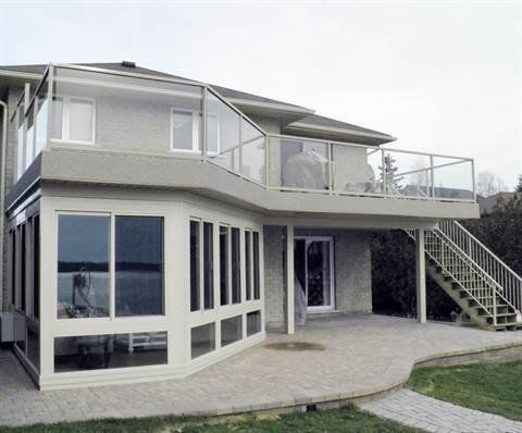 A large house with a large deck and stairs