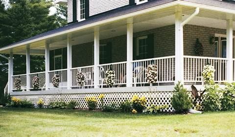 A house with a large porch and a white railing