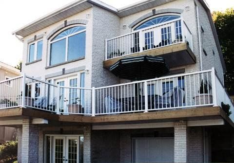 A large house with a balcony and a garage