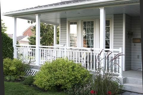 A white house with a porch and a white railing