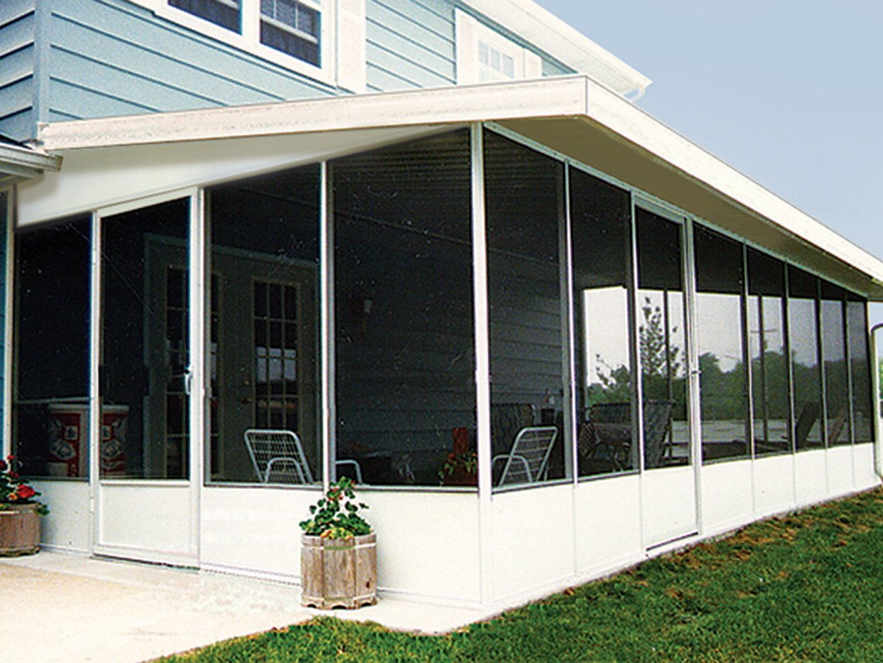 A screened in porch with a planter in front of it