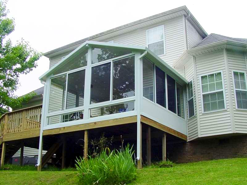 A house with a screened in porch and a deck