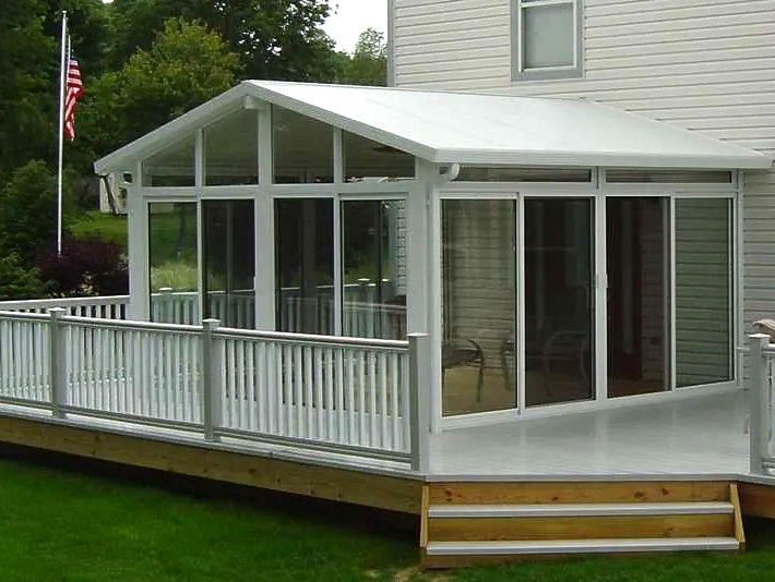 A white house with a screened in porch and stairs