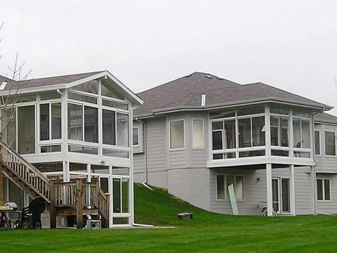 A house with a screened in porch and a deck