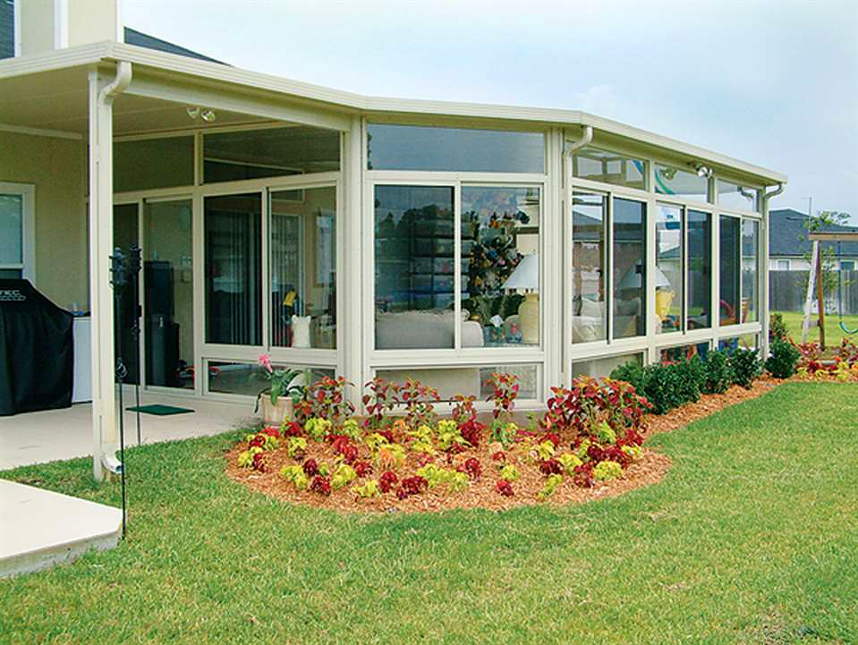 A house with a sunroom with a lot of windows