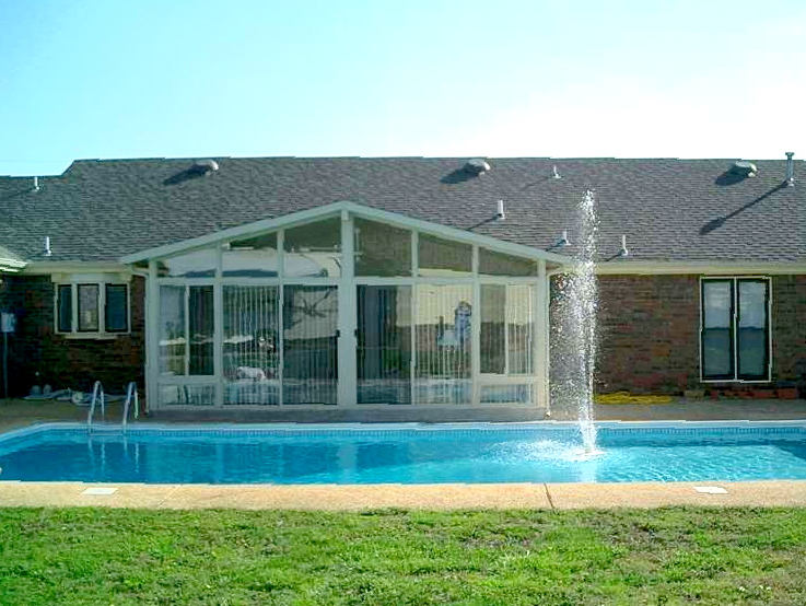 A house with a swimming pool in front of it