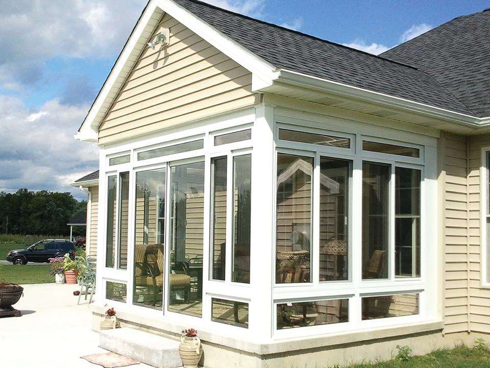 A house with a sunroom with lots of windows