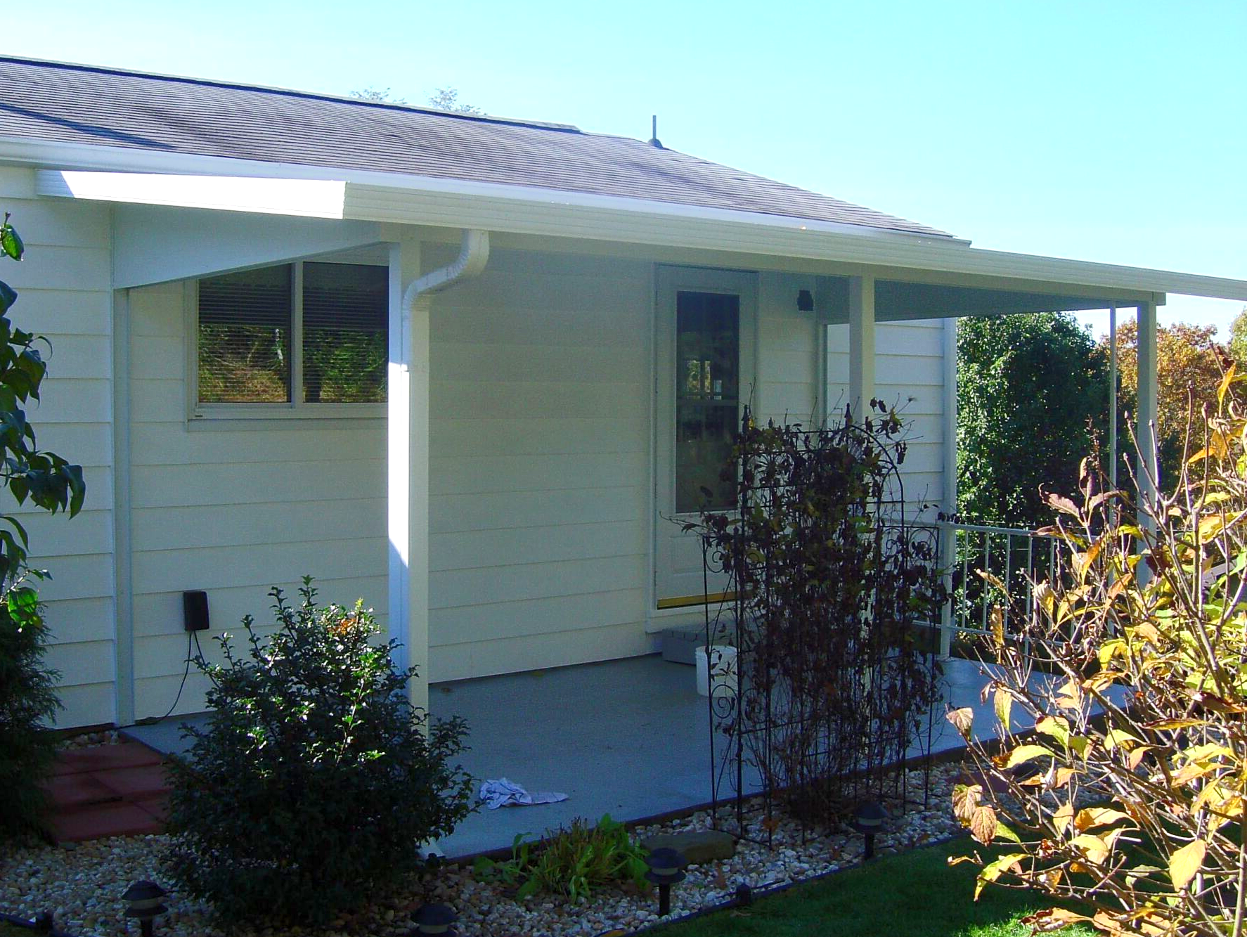 A white house with a porch and a sign that says ' a ' on it