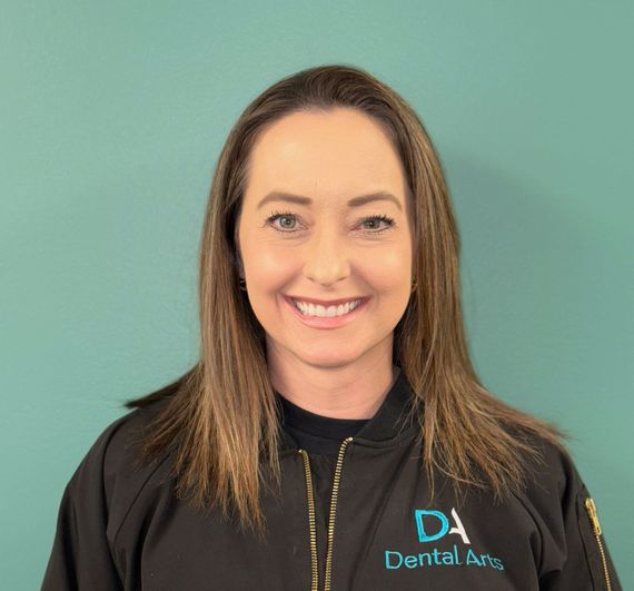 A woman in a black shirt is smiling for the camera.
