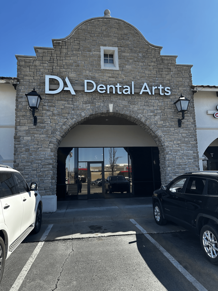 The front of a dental arts office in the snow.