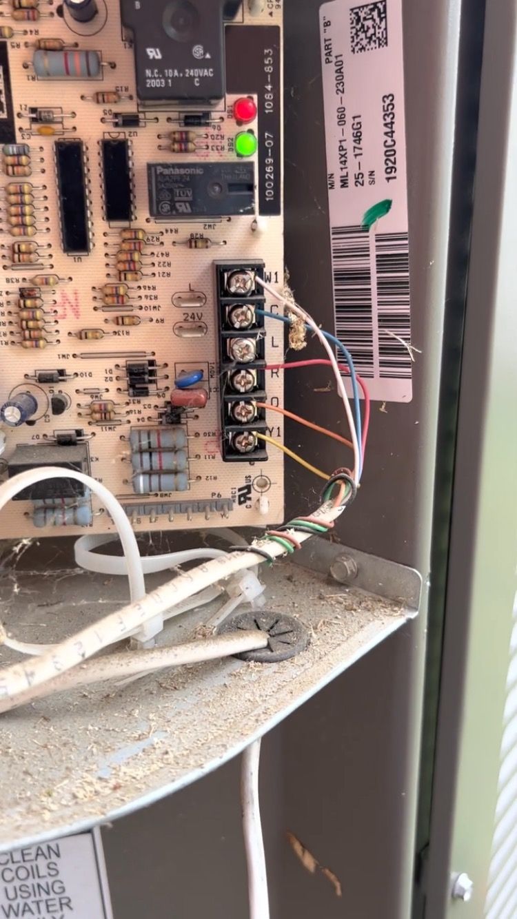 A close up of a circuit board with wires coming out of it.