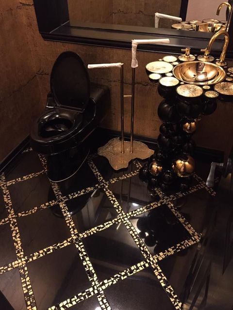 A bathroom with a toilet a sink and a mirror