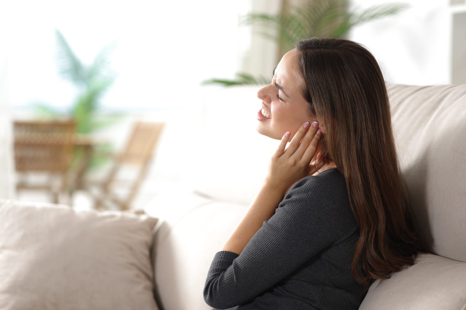 woman suffering earache at home