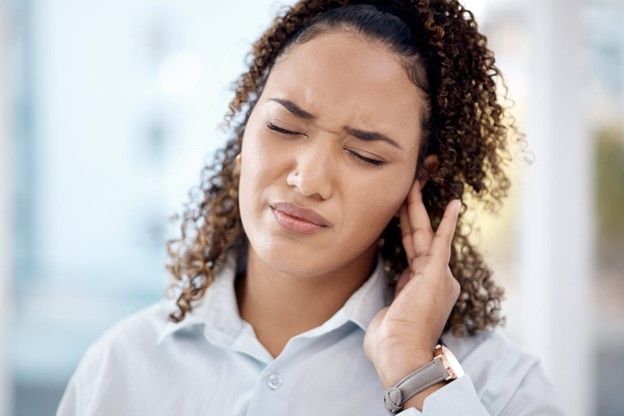 woman having an ear pain in one ear