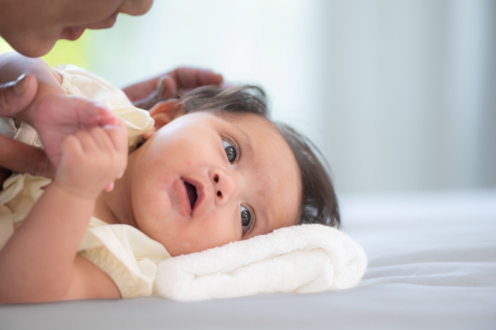 Mother checking her baby ear's wax