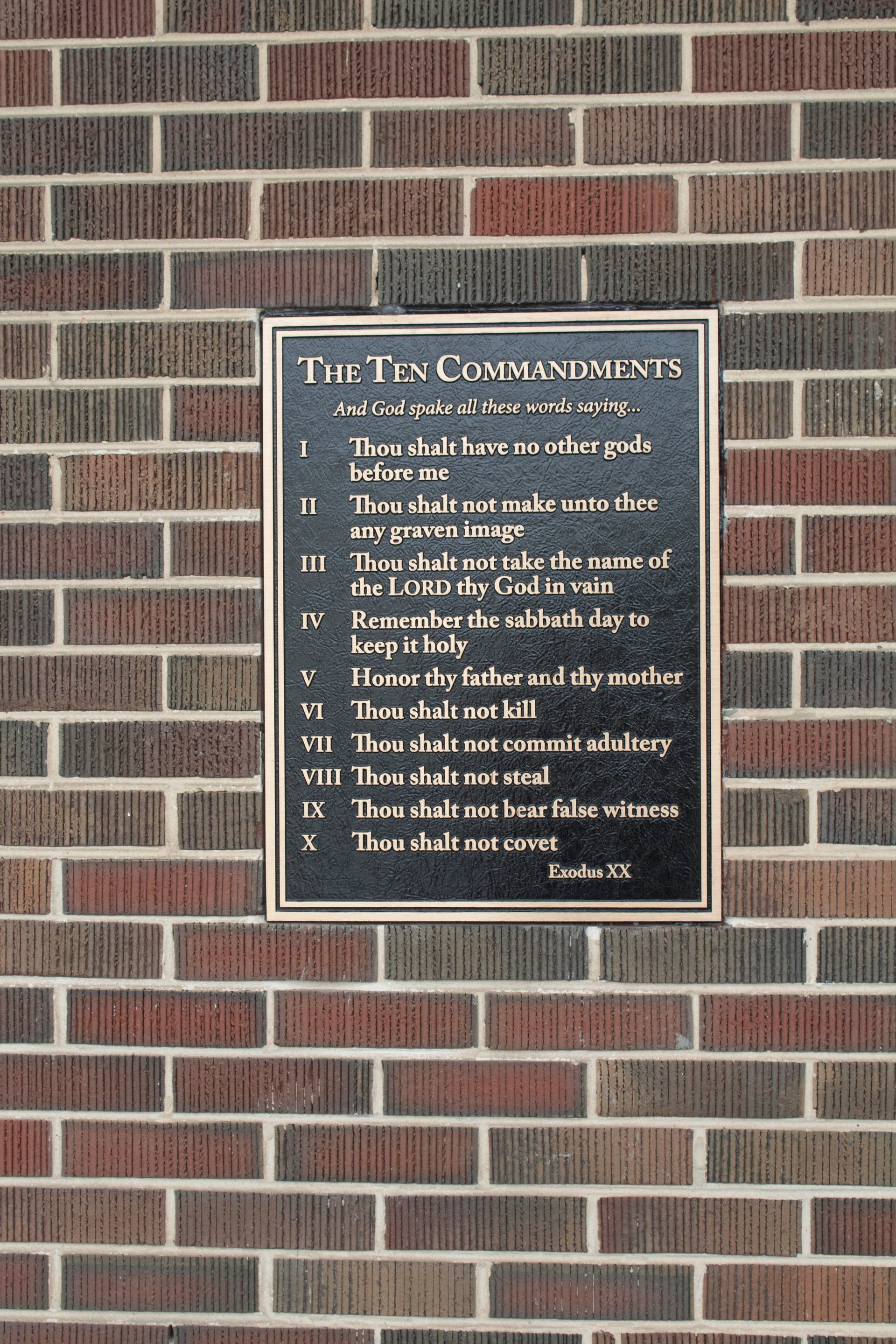 A brick wall with a sign on it that says district communion