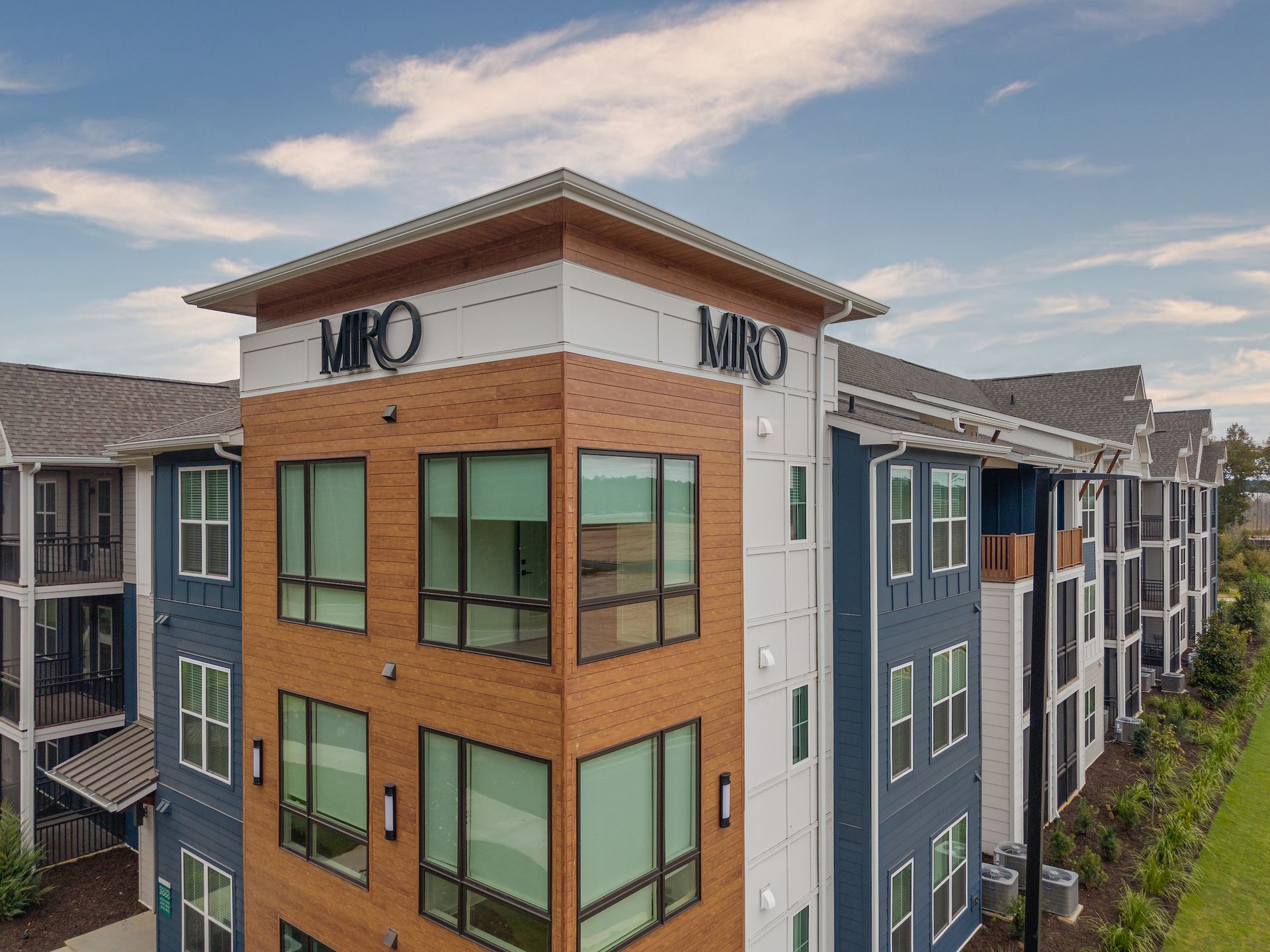 Modern apartment building with blue and brown siding, 