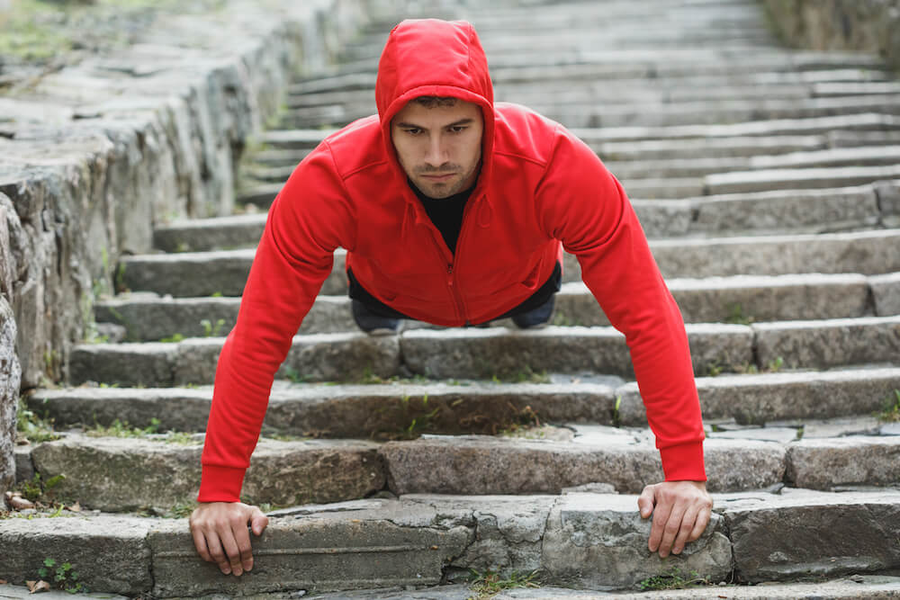 Man performing a pushup on steps