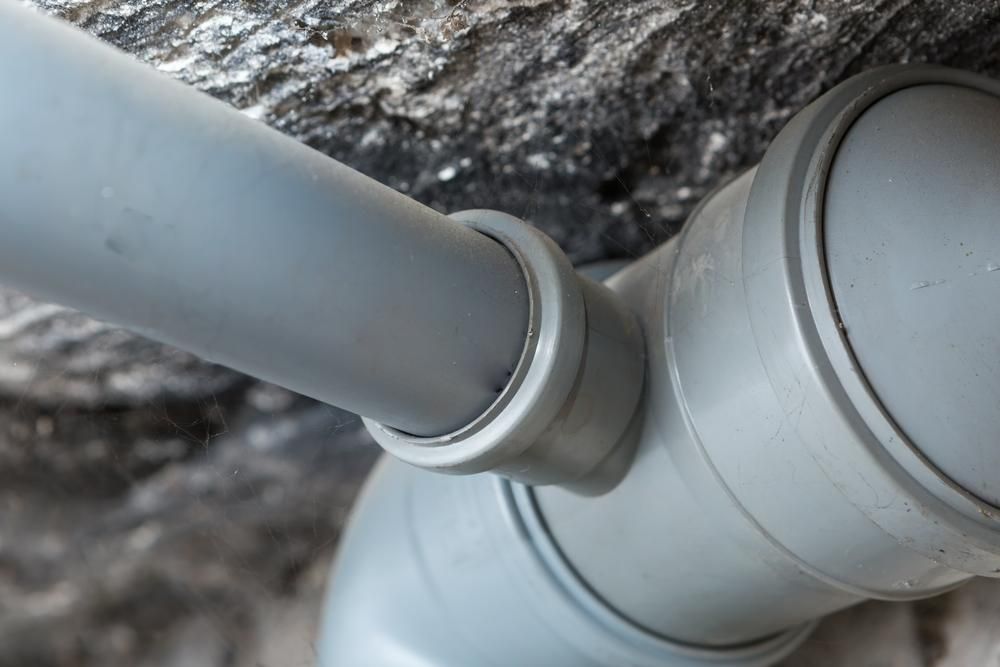 A Close up Of a Gray Pipe Connected to A Wall — Howard Hardware and Building Supplies in Howard, QLD