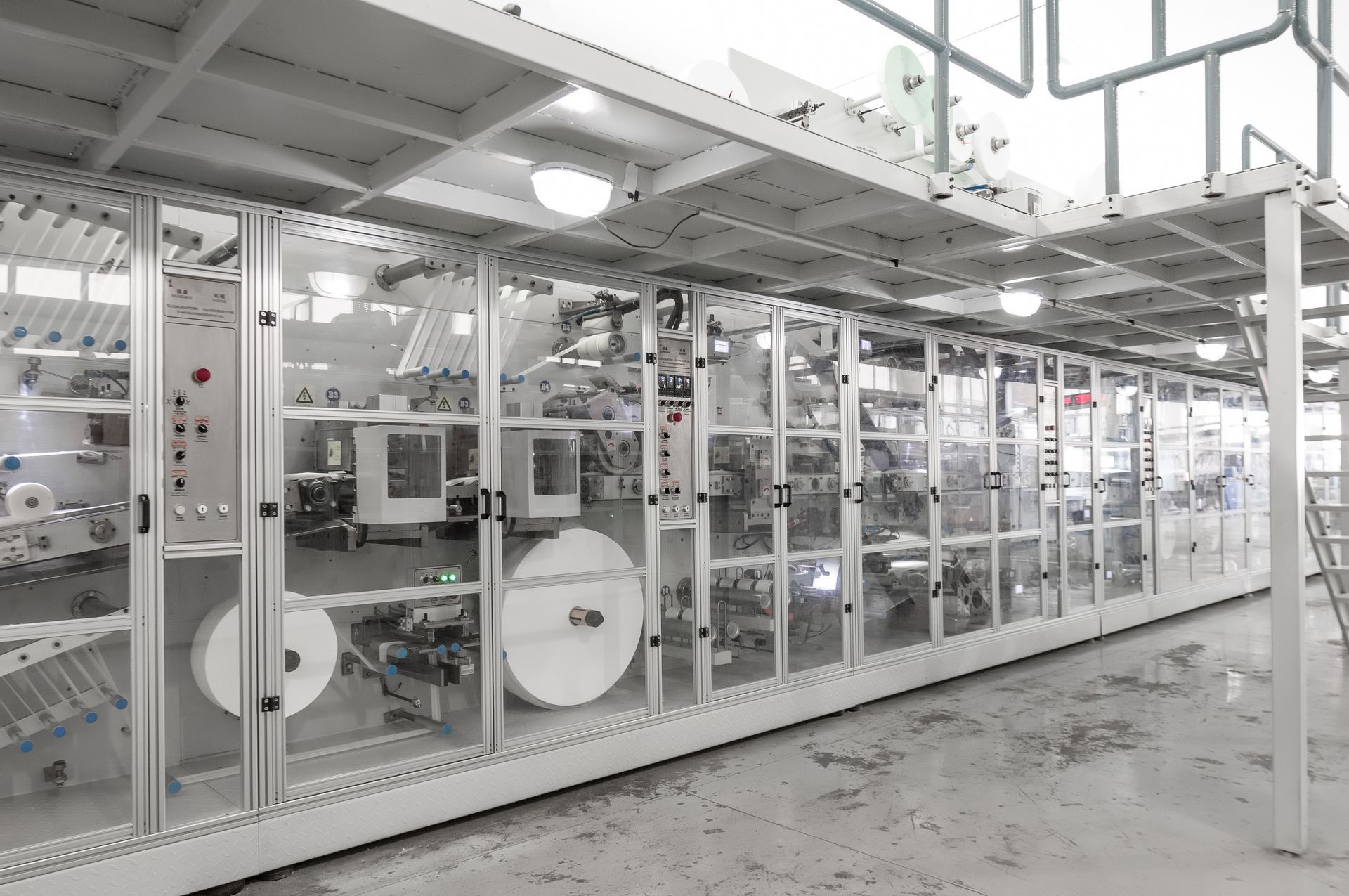 a large labeling machine is sitting inside of a factory .