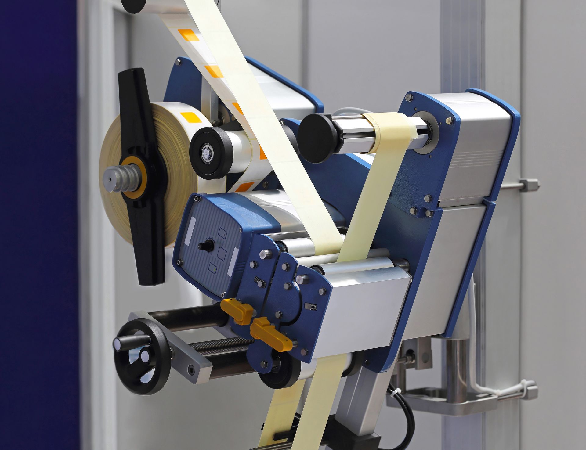 a machine with a roll of labels on it