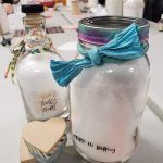 A couple of jars sitting on top of a table.