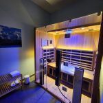 A room with a sauna and a couch in it.